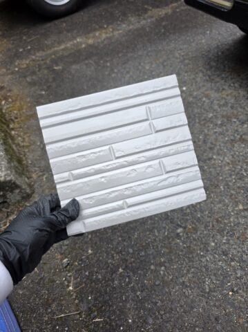 金属サイディングの裏面にぎっしり詰まった断熱材の厚みがわかる製品の拡大写真